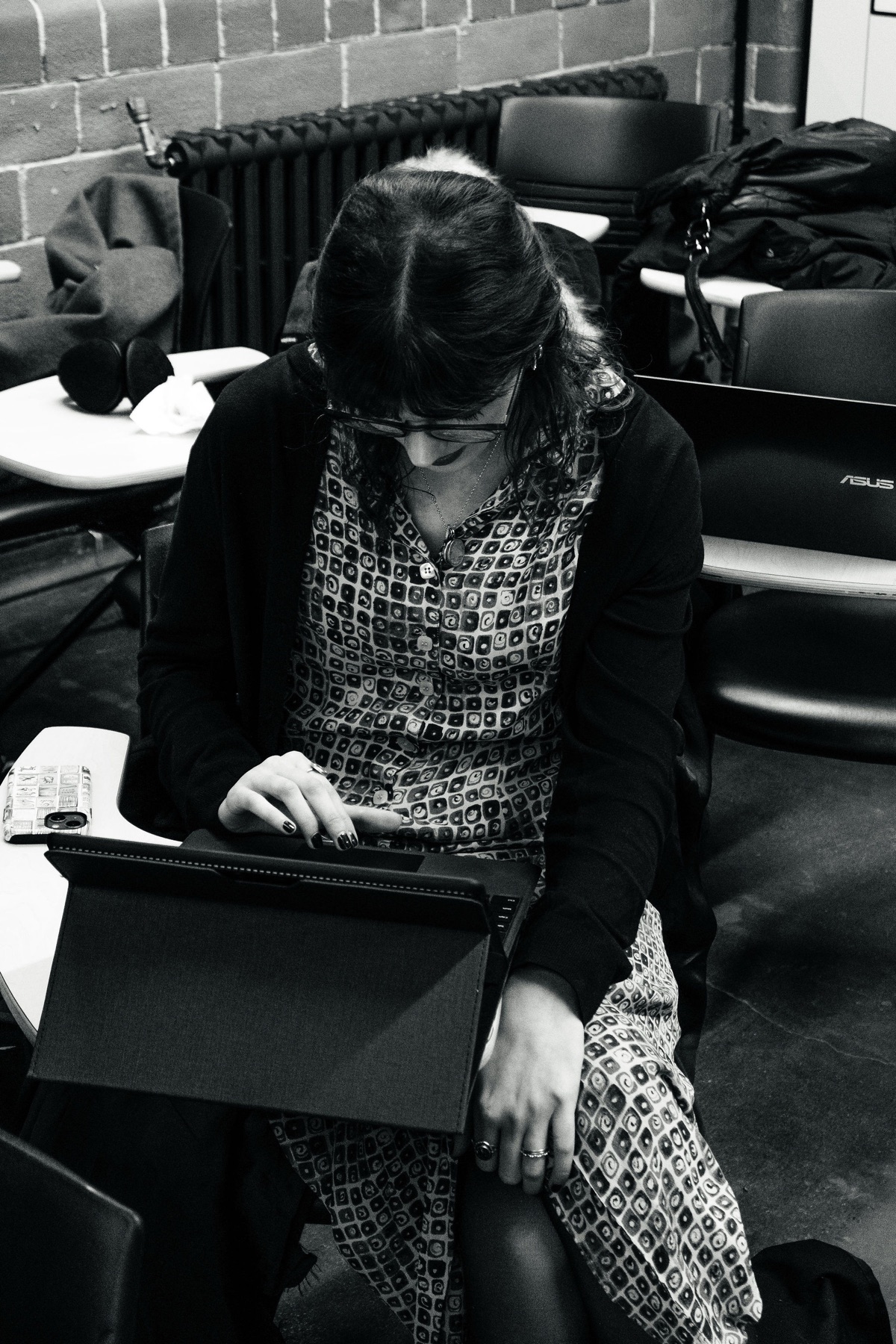 A participant sketches on a tablet during the workshop, in black and white