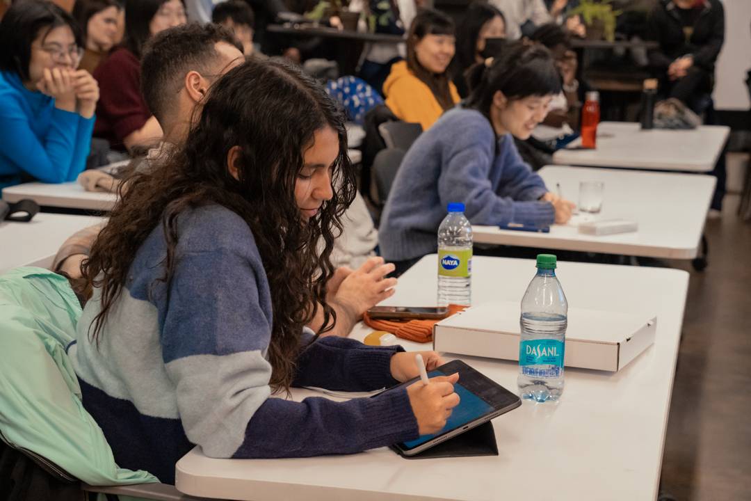 An attendee sketches on a tablet during the panel