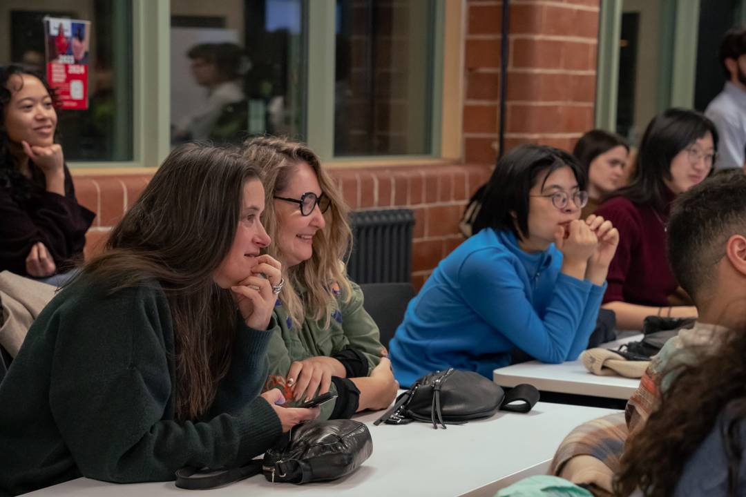 Audience members share a light moment during the conversation