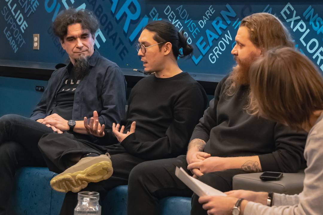 Andrew Gray speaks while Michal Seta and Guillaume Borgomano listen