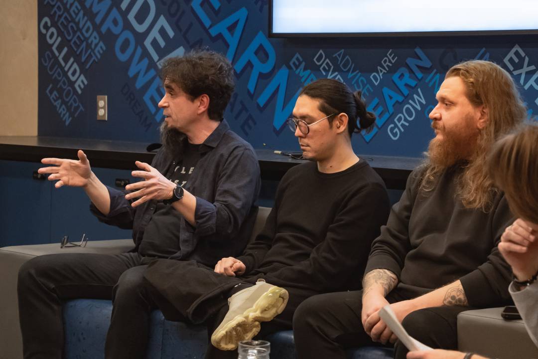 Michal Seta gestures while answering a question from the audience